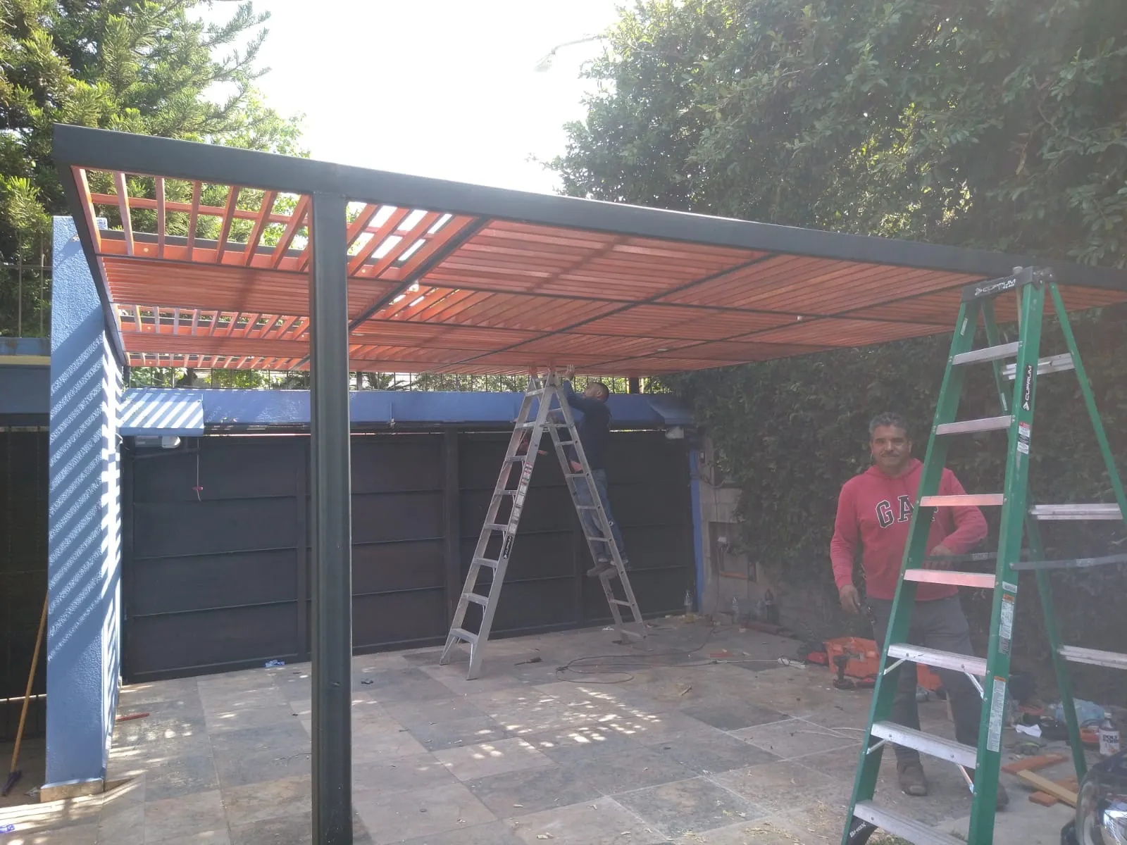 Equipo de Techandote instalando una pérgola de acero con celosía de madera